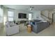 Bright living room featuring tile floors, modern furnishings and a large-screen television at 1077 Fountain Coin Loop, Orlando, FL 32828