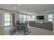 Open floor plan with large windows, tile floors, and view to the pool at 1077 Fountain Coin Loop, Orlando, FL 32828