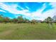 Community playground with a large grassy field, mature trees, and recreational amenities for Gathering enjoyment at 1077 Fountain Coin Loop, Orlando, FL 32828