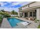 Inviting pool area with sun shelf, adjacent to covered patio with lounge and grill at 1077 Fountain Coin Loop, Orlando, FL 32828