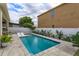 Clean pool in private backyard with lounge chairs, surrounded by well-kept pavers and a white privacy fence at 1077 Fountain Coin Loop, Orlando, FL 32828