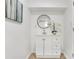Bright bathroom vanity features white cabinets, black round mirror, and white orchid at 1300 Montego Ln, Orlando, FL 32807