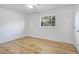 Clean bedroom features a window for natural light and light wood flooring at 1300 Montego Ln, Orlando, FL 32807