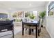 Contemporary dining area with a table set for four, seamlessly integrated into the living space at 1300 Montego Ln, Orlando, FL 32807