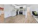 Modern, updated kitchen with stainless steel appliances, white cabinets, and wood-look floors at 1300 Montego Ln, Orlando, FL 32807