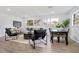 Spacious living room featuring a large rug, contemporary furnishings, and natural light from multiple windows at 1300 Montego Ln, Orlando, FL 32807