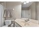 Clean bathroom featuring a vanity with a large mirror and a toilet at 1357 Venezia Ct # 402, Davenport, FL 33896
