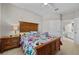 Bedroom featuring a wooden bed frame, nightstand, and access to the bathroom at 1357 Venezia Ct # 402, Davenport, FL 33896