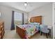 Comfortable bedroom with a wooden bed frame, floral bedding, and a window at 1357 Venezia Ct # 402, Davenport, FL 33896