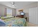 Bedroom with two beds, dresser, and natural light from window at 1357 Venezia Ct # 402, Davenport, FL 33896