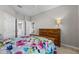 Bedroom with wooden dresser and access to bathroom and closets at 1357 Venezia Ct # 402, Davenport, FL 33896