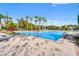 Enjoy the large community pool with an ample deck, mature landscaping, and bright blue sky at 1357 Venezia Ct # 402, Davenport, FL 33896