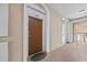 Condo hallway with door 402, neutral walls and an 'Exit' sign visible towards the outdoor area at 1357 Venezia Ct # 402, Davenport, FL 33896