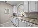 Bright kitchen featuring white cabinetry, tiled floor, and neutral countertops and backsplash at 1357 Venezia Ct # 402, Davenport, FL 33896