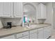 Well-lit kitchen with open counter view to living room, white appliances, and ample cabinets at 1357 Venezia Ct # 402, Davenport, FL 33896