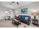 Cozy living room featuring a leather couch with blue pillows and stylish decor at 1357 Venezia Ct # 402, Davenport, FL 33896
