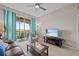 Inviting living room with balcony, neutral walls, plush carpeting, and a modern TV setup at 1357 Venezia Ct # 402, Davenport, FL 33896