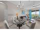 Bright living room leading to a balcony, with a dining area and comfortable seating at 1357 Venezia Ct # 402, Davenport, FL 33896