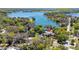 Expansive aerial view showcasing the home's setting near the beautiful East Crooked Lake and lush greenery at 1400 Tedford St, Eustis, FL 32726