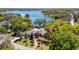 Stunning aerial shot of house backing up to lake, surrounded by mature trees and lush landscaping at 1400 Tedford St, Eustis, FL 32726