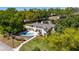 Aerial view of a beautiful home with a pool and lush landscaping in a serene neighborhood at 1400 Tedford St, Eustis, FL 32726