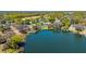 Scenic aerial view of a lakeside community featuring beautiful homes with docks and boat access to the water at 1400 Tedford St, Eustis, FL 32726