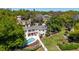 Aerial view of a two-story home with a pool, lounge area, and green lawn surrounded by mature trees at 1400 Tedford St, Eustis, FL 32726