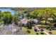 Aerial view of beautiful house nestled amongst trees and fronting the water at 1400 Tedford St, Eustis, FL 32726