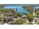 Expansive aerial view showcasing the home's setting near the beautiful East Crooked Lake and lush greenery at 1400 Tedford St, Eustis, FL 32726