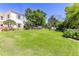 Expansive backyard with a lush green lawn and shade trees at 1400 Tedford St, Eustis, FL 32726