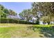 Picturesque backyard with mature trees, offering a serene view of the lake at 1400 Tedford St, Eustis, FL 32726