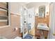 Bright bathroom with decorative tiles, a sink, and a view into the connecting bedroom offering great light at 1400 Tedford St, Eustis, FL 32726