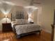 The main bedroom includes a bed, two nightstands and hardwood floors at 1400 Tedford St, Eustis, FL 32726