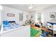 Cozy bedroom featuring bright decor, a ceiling fan, two windows, and hardwood flooring at 1400 Tedford St, Eustis, FL 32726