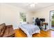This bedroom includes a bed, couch, and desk at 1400 Tedford St, Eustis, FL 32726
