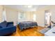Inviting bedroom with hardwood floors, soft lighting, and a comfortable seating area for relaxation at 1400 Tedford St, Eustis, FL 32726