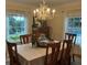 Elegant dining room with chandelier, decorative table setting and two windows at 1400 Tedford St, Eustis, FL 32726