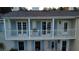 Elegant two-story home featuring a covered balcony with white railings and blue shutters overlooking the property at 1400 Tedford St, Eustis, FL 32726