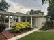 Charming single-story home featuring a covered front porch and well-manicured landscaping at 1400 Tedford St, Eustis, FL 32726