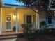 Charming front porch featuring brick accents, a wreath, and a well-lit entryway at 1400 Tedford St, Eustis, FL 32726