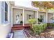 Charming front porch with brick accents, columns, and a well-maintained garden at 1400 Tedford St, Eustis, FL 32726