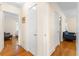 Bright hallway with hardwood floors and neutral paint, offering access to multiple rooms in the home at 1400 Tedford St, Eustis, FL 32726