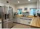 This kitchen includes butcher block countertops and stainless-steel appliances at 1400 Tedford St, Eustis, FL 32726