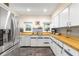 Bright kitchen featuring white cabinets, wood countertops, and stainless steel appliances at 1400 Tedford St, Eustis, FL 32726