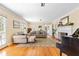 Bright living room with hardwood floors, fireplace, plush seating, and French doors at 1400 Tedford St, Eustis, FL 32726
