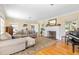 Bright living room boasts hardwood floors, fireplace, and grand piano at 1400 Tedford St, Eustis, FL 32726