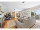 Spacious living room with piano and open balcony access at 1400 Tedford St, Eustis, FL 32726