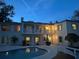 Twilight view of home with a swimming pool and a rear balcony, illuminated by warm interior lights at 1400 Tedford St, Eustis, FL 32726