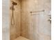 Walk in shower with beige tile, rainfall showerhead and bench at 1400 Tedford St, Eustis, FL 32726