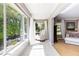 Sunny sitting area features tile floors, a rocking chair, and scenic outdoor views at 1400 Tedford St, Eustis, FL 32726